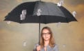 Woman under umbrella Stimulus spending will likely harm Canadian economy, not help it