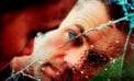 Man looking through cracked glass Daily text message service helps with stress, depression during COVID-19